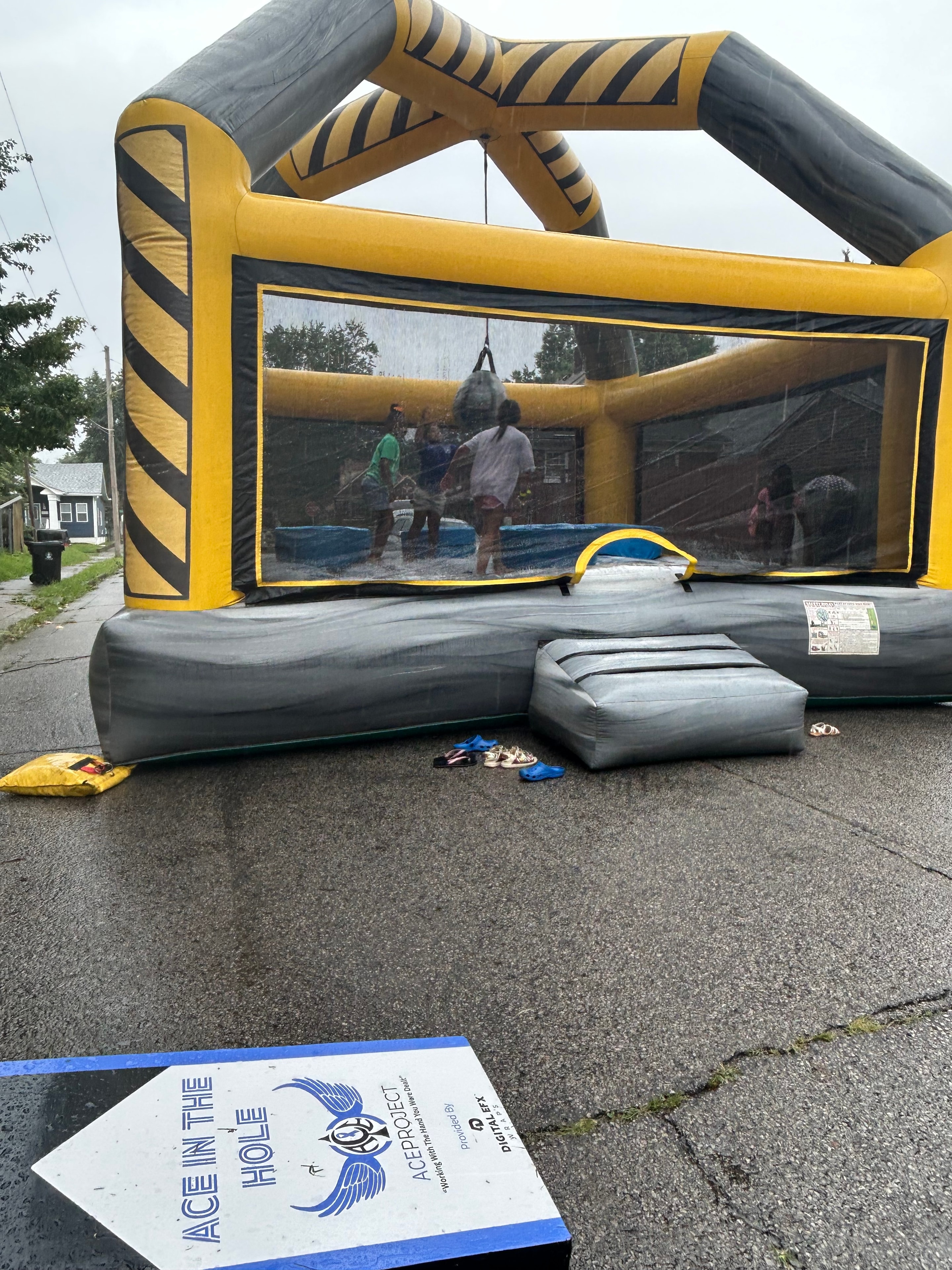 Kids playing in ACE in the Hole inflatable bounce house at block party