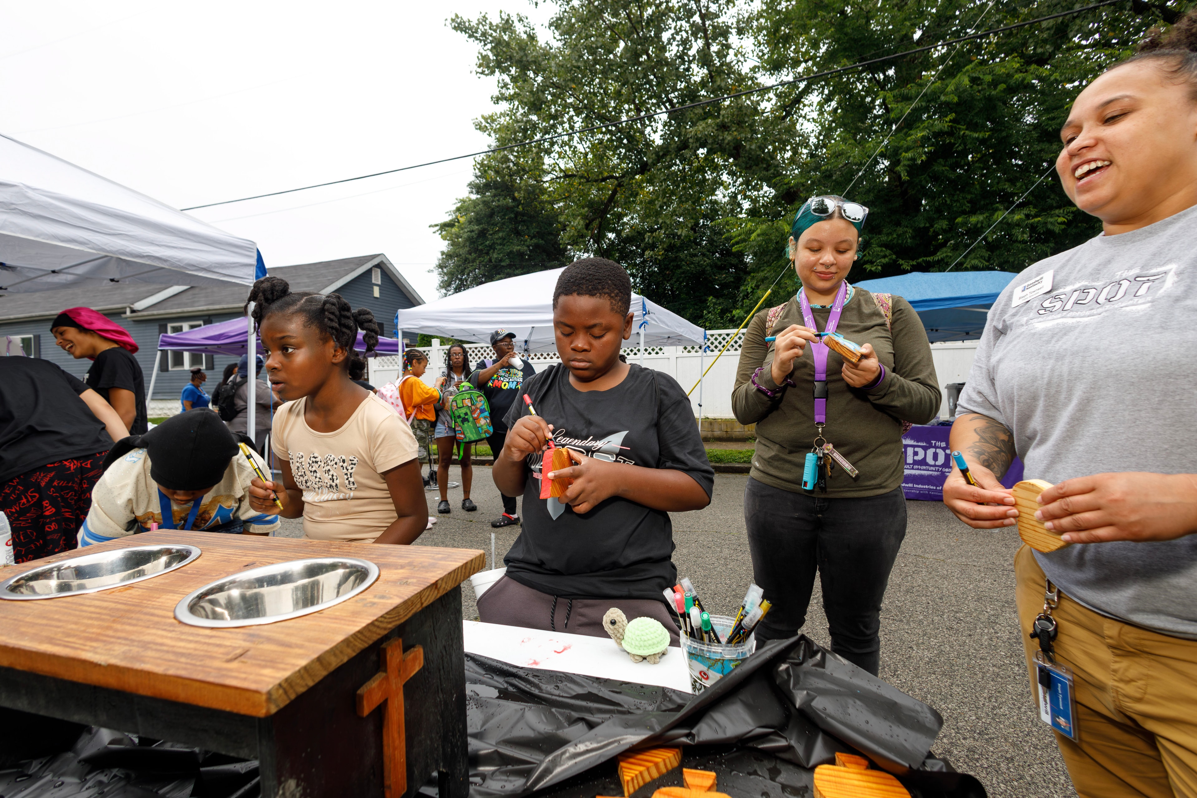 Children and volunteers doing woodworking crafts at ACE Way block party