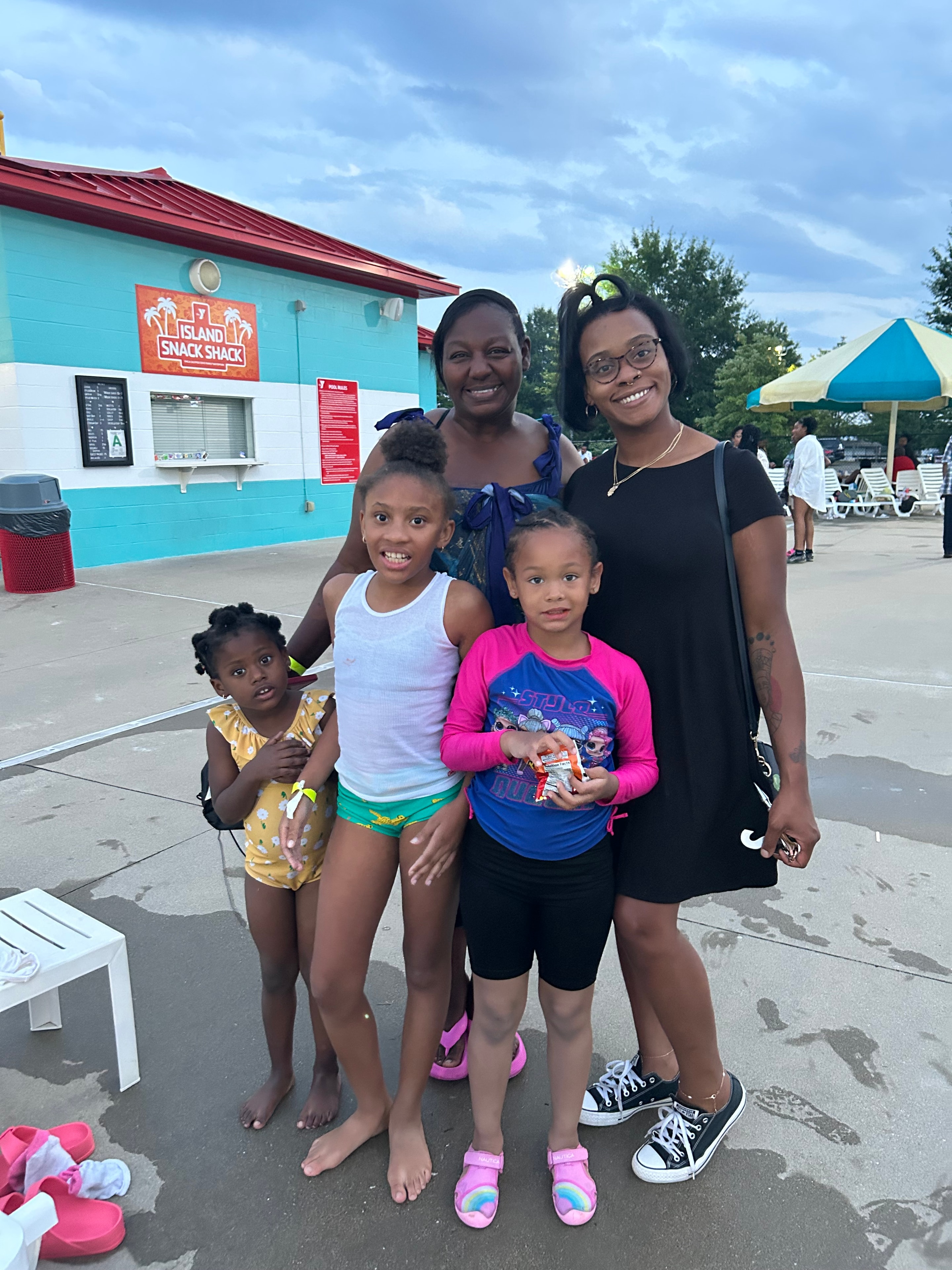 Family with children posing at Island Snack Shack at ACE Project summer outing