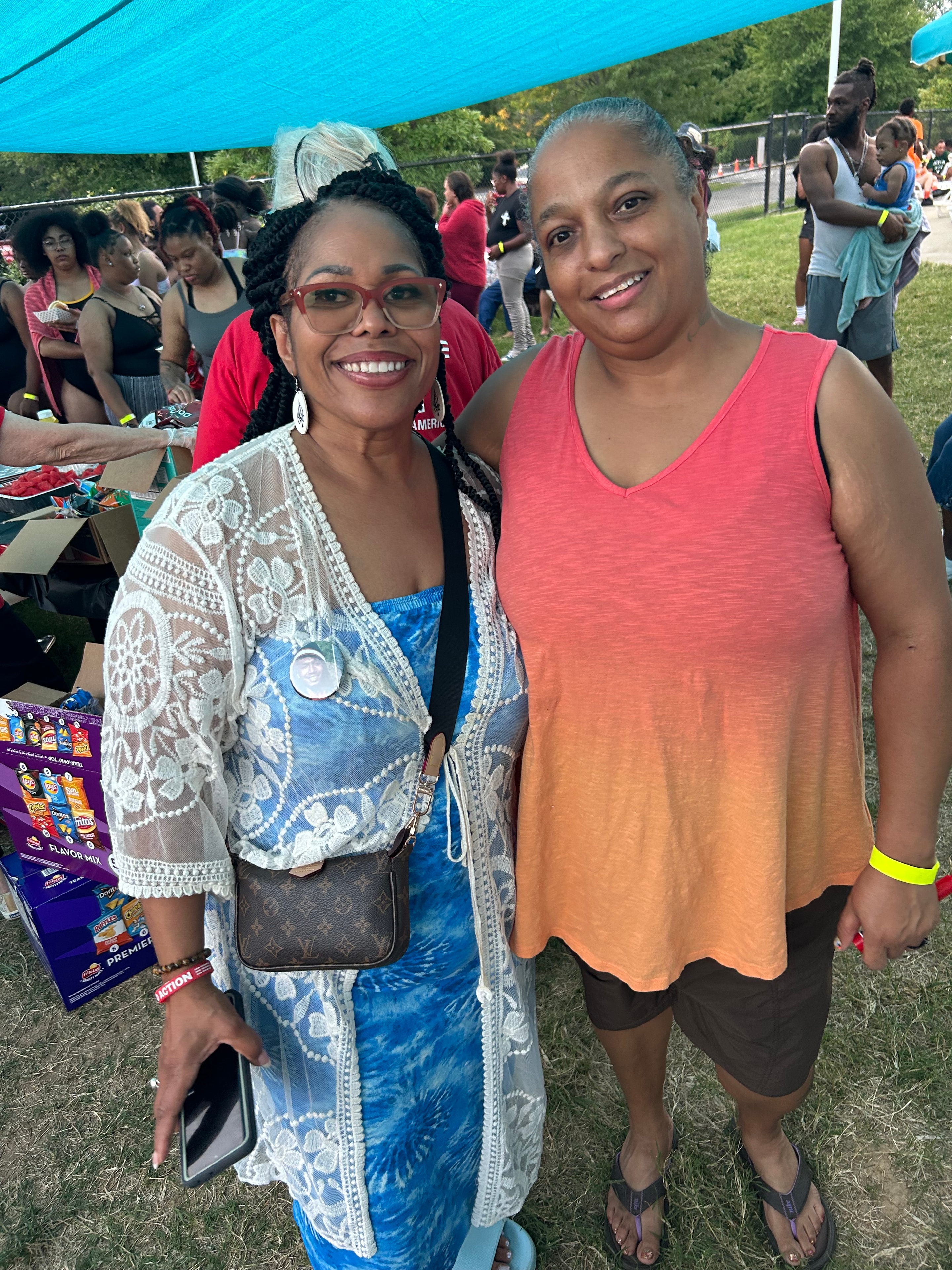 Two women smiling together at ACE Project community outdoor event