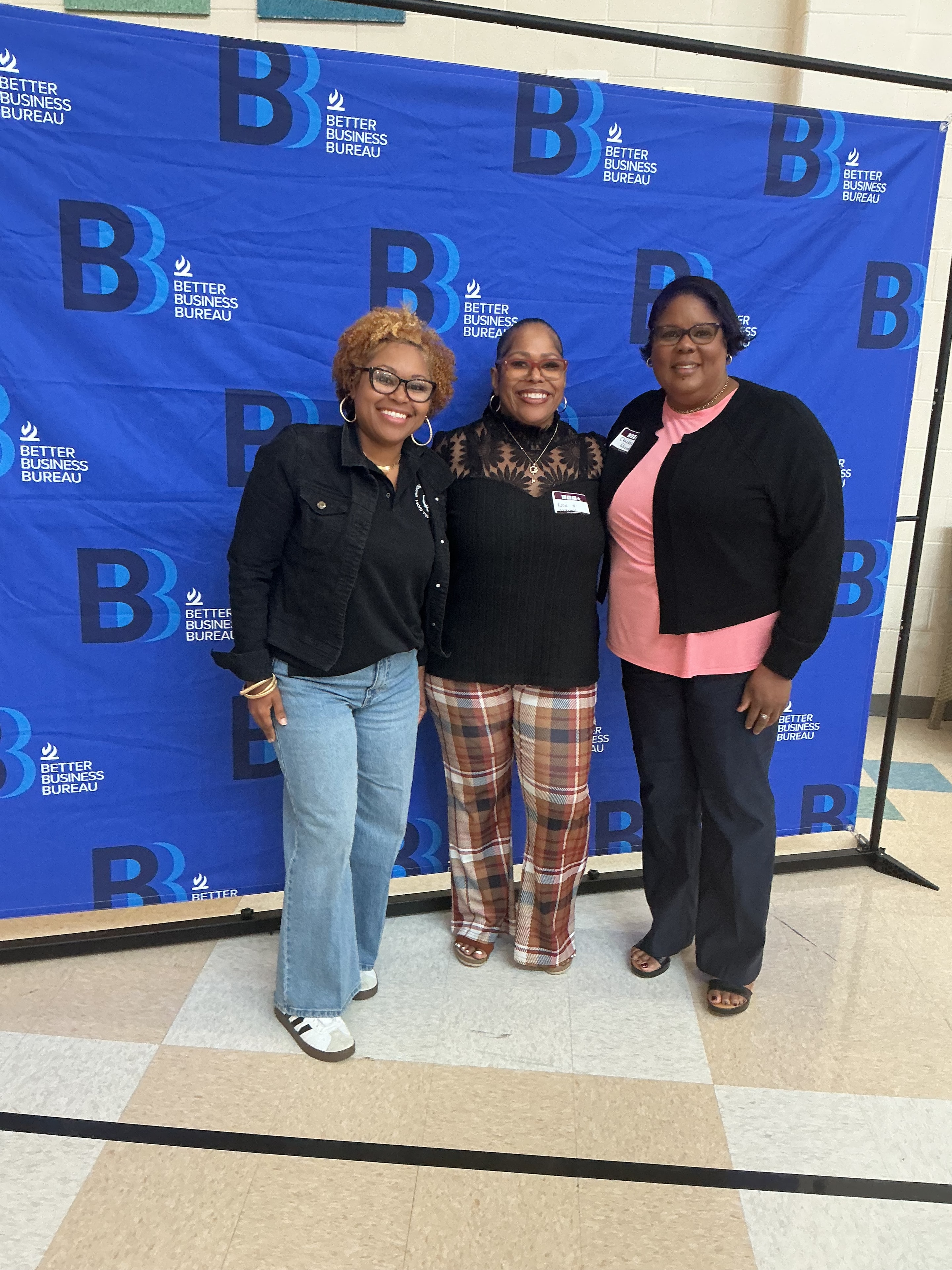 Three ACE Project members posing at Better Business Bureau event
